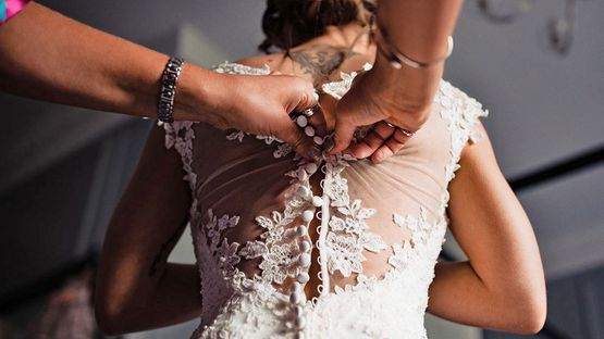 A wedding dress being worked on