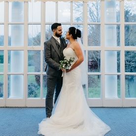 Bride in white wedding dress and groom in grey suit